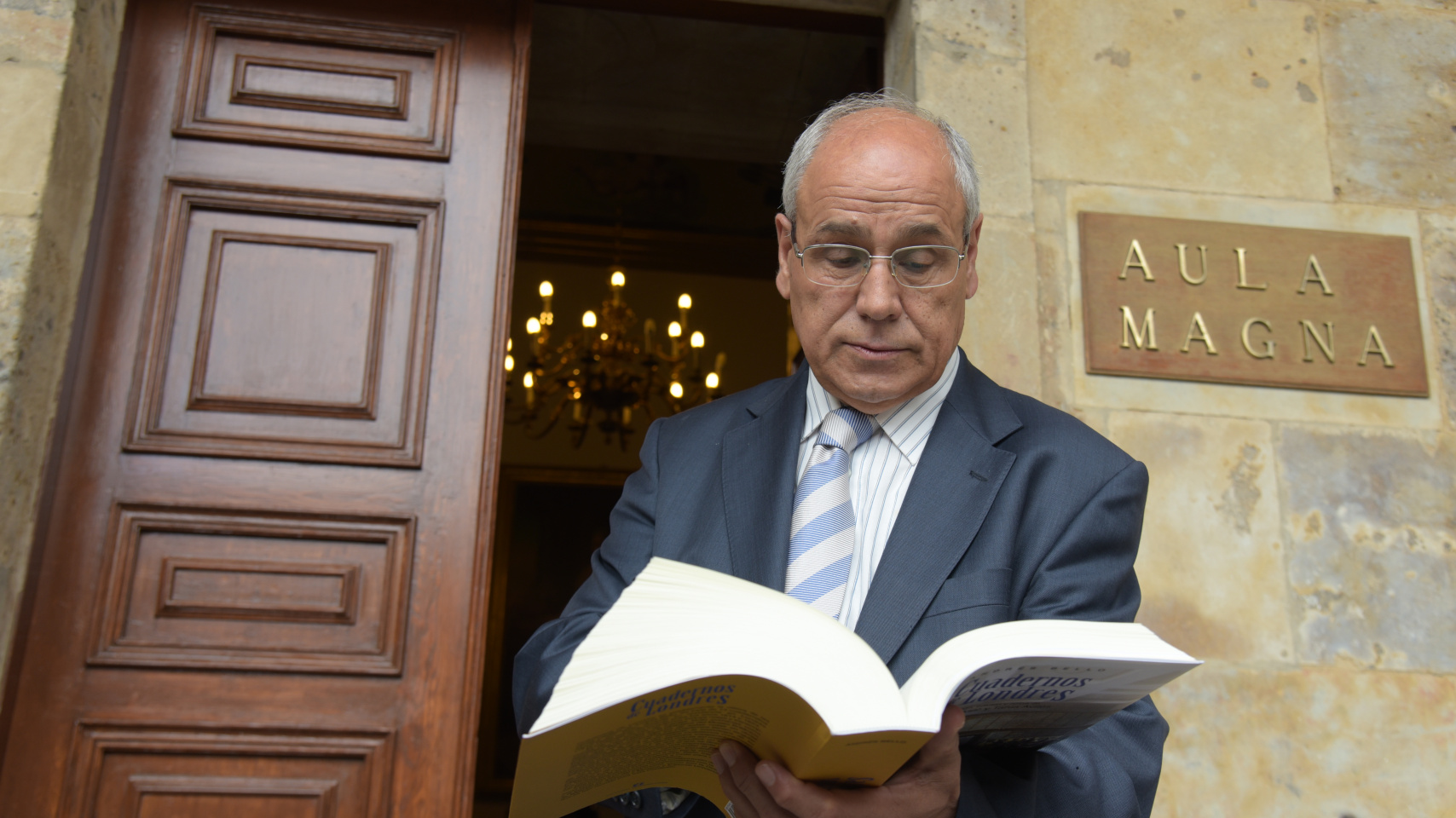 El director de la Cátedra de Altos Estudios del Español hojeando el libro presentado en el acto