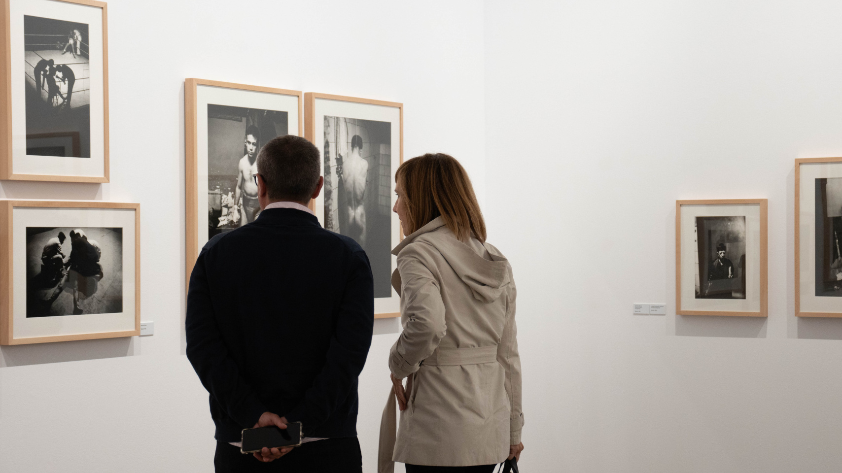 Visitantes de la exposición admirando las fotografías